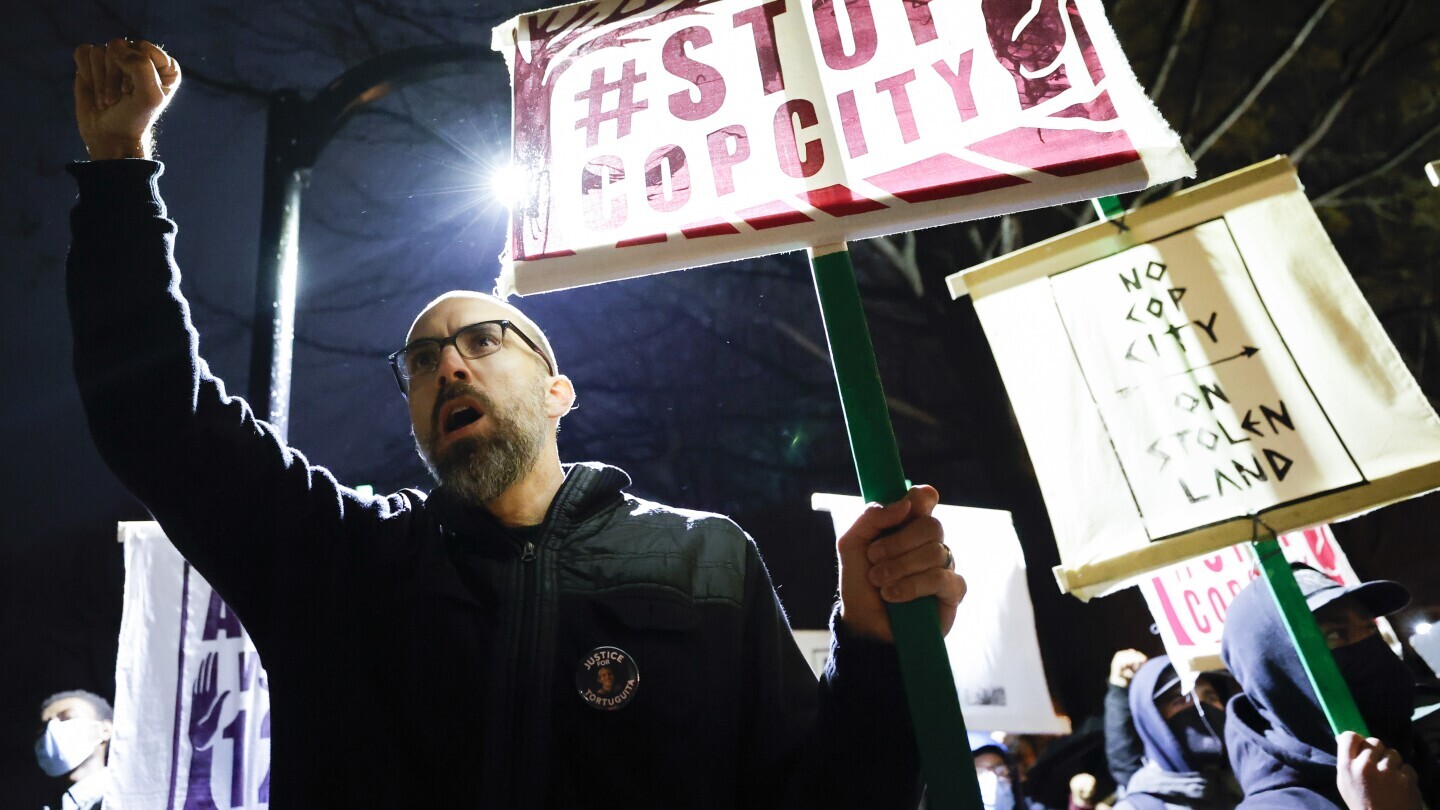 Andrew Douglas, of Atlanta, raises his fist during a protest over plans to build a police training center, March 9, 2023, in Atlanta. (AP Photo/Alex Slitz, file)
