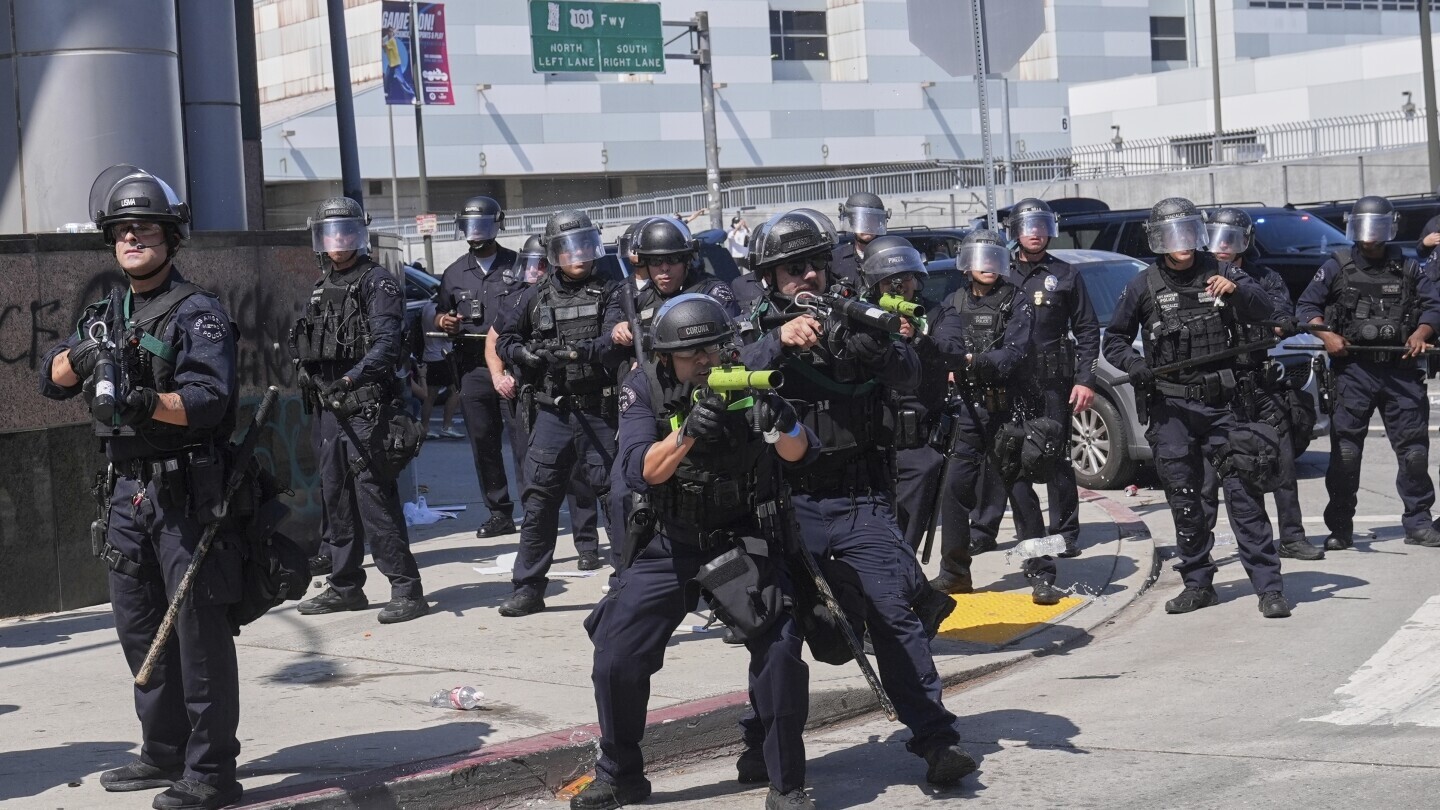 Police defend the Metropolitan Detention Center in downtown Los Angeles, June 8, 2025, following an immigration raid protest the previous day.(AP Photo/Jae Hong, File)